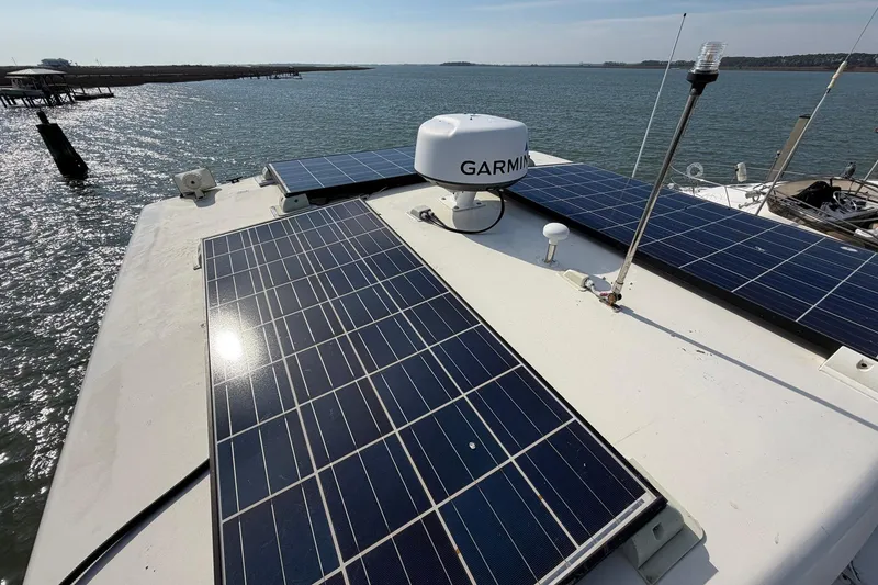 Slide: The Image of Solar panels on 1987 Viking 44 Motor Yacht, with Garmin equipment, docked by the water. - 87