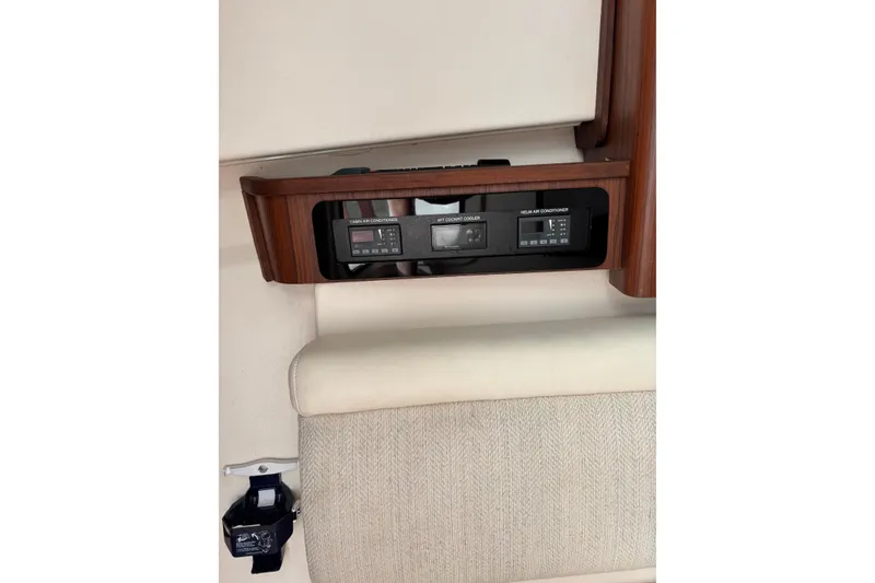 Slide: The Image of 2018 Grady-White Freedom 375 cabin air conditioner controls with wood paneling. - 10