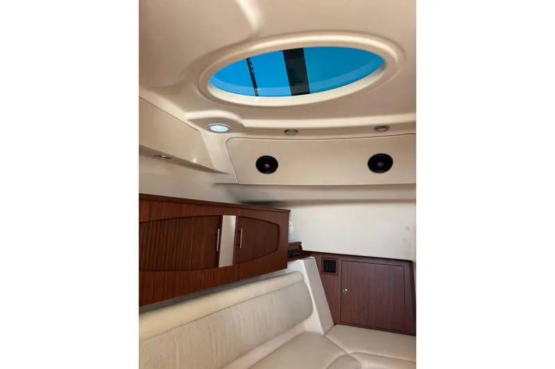 Slide: The Image of Interior of 2018 Grady-White Freedom 375 boat with wood cabinetry and skylight. - 11