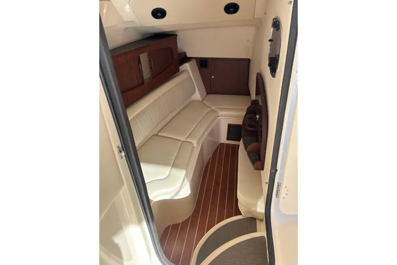 Slide: The Image of 2018 Grady-White Freedom 375 cabin interior with white seating and wood accents. - 14