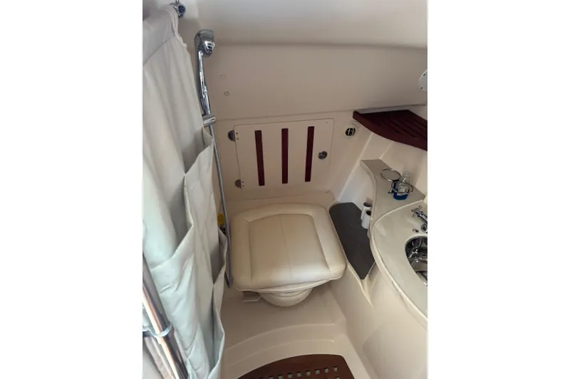 Slide: The Image of 2018 Grady-White Freedom 375 boat bathroom with toilet, sink, and shower curtain. - 17