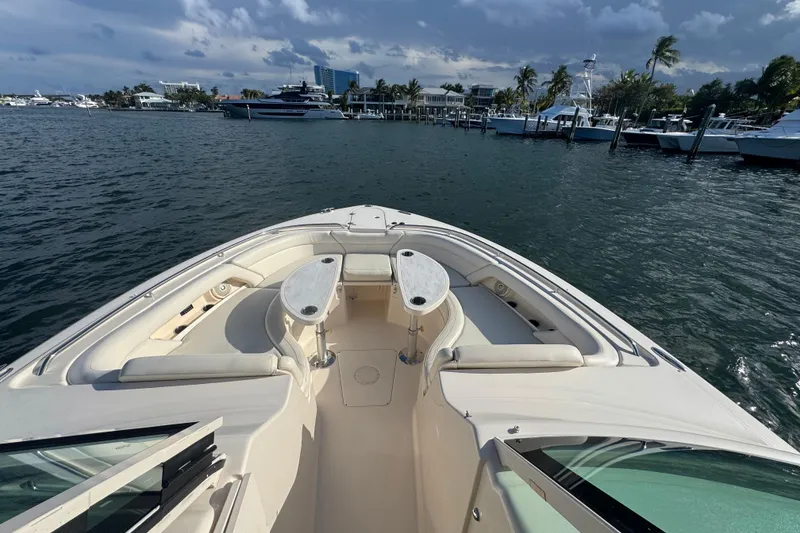 Slide: The Image of 2018 Grady-White Freedom 375 boat with spacious seating, docked in a marina. - 3