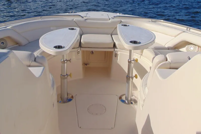Slide: The Image of 2018 Grady-White Freedom 375 boat interior with seating and tables on water. - 6