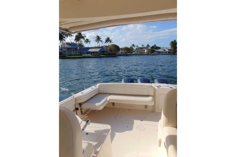 Slide: The Image of 2018 Grady-White Freedom 375 boat interior with waterfront view and palm trees. - 8