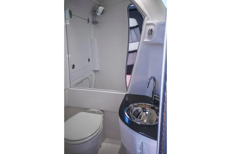 Slide: The Image of Manufacturer Provided Image: 2020 Nor-Tech 450 Sport Center Console bathroom with modern sink and toilet. - 12