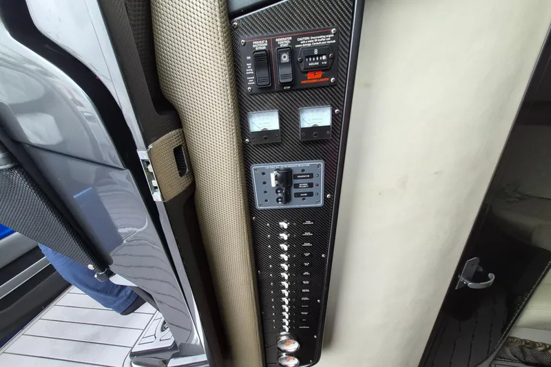 Slide: The Image of Control panel of 2020 Nor-Tech 450 Sport Center Console boat with switches and gauges. - 23