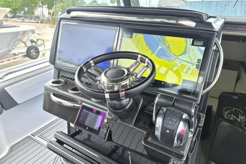 Slide: The Image of 2020 Nor-Tech 450 Sport Center Console dashboard with navigation screens and steering wheel. - 24