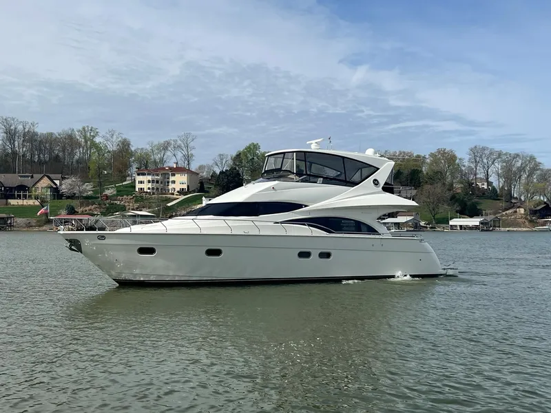 The Image of 2005 Marquis 59 luxury yacht cruising on a serene lake. - 0