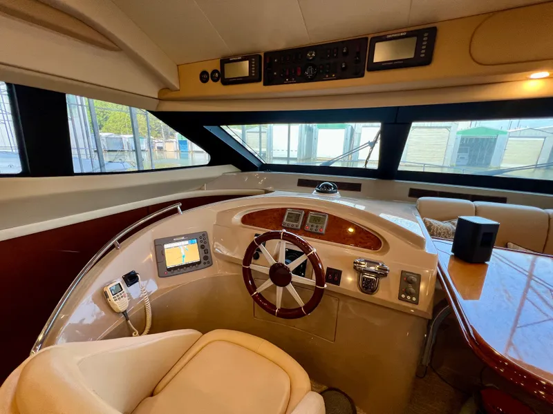 Slide: The Image of Interior view of the helm console on a 2005 Marquis 59 yacht. - 10