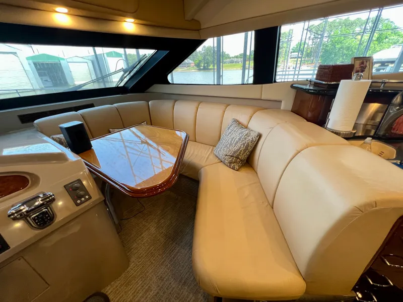 Slide: The Image of Luxurious interior of a 2005 Marquis 59 yacht with leather sofa and wooden table. - 11