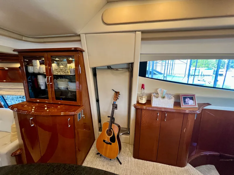 Slide: The Image of Interior of a 2005 Marquis 59 yacht with guitar and cabinets. - 17