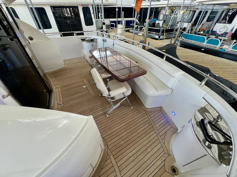 Slide: The Image of Luxurious deck of a 2005 Marquis 59 with wooden flooring and seating area. - 37