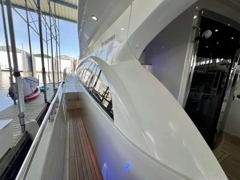 Slide: The Image of 2005 Marquis 59 yacht docked, showcasing sleek design. - 39