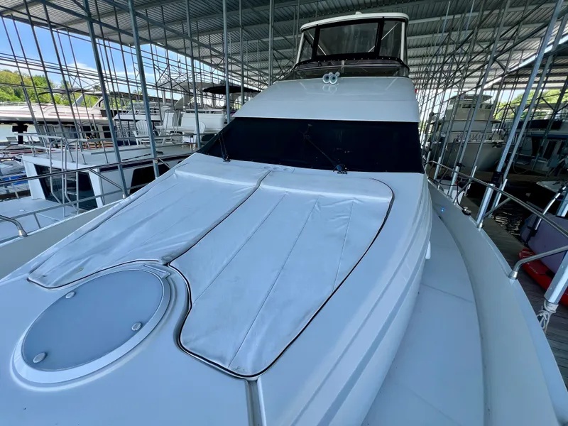 Slide: The Image of 2005 Marquis 59 yacht docked under a covered marina. - 41