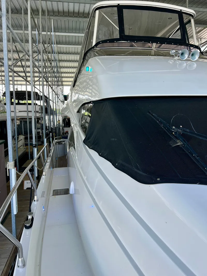 Slide: The Image of 2005 Marquis 59 yacht docked, side view. - 46