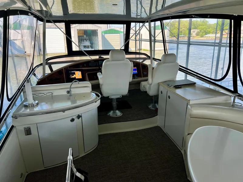 Slide: The Image of Interior of a 2005 Marquis 59 yacht with helm and seating area. - 48