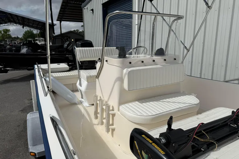 Slide: The Image of 2002 McKee Craft WayPoint boat with white seating and console, docked outdoors. - 12