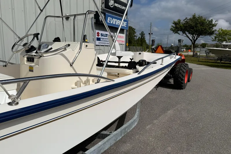 Slide: The Image of 2002 McKee Craft WayPoint boat on trailer, parked outdoors near dealership signs. - 3