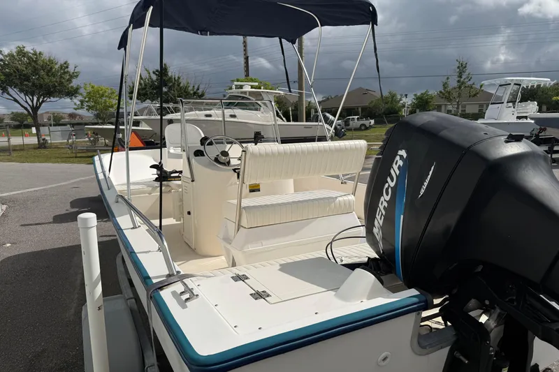 Slide: The Image of 2002 McKee Craft WayPoint boat with Mercury outboard motor, parked outdoors. - 4