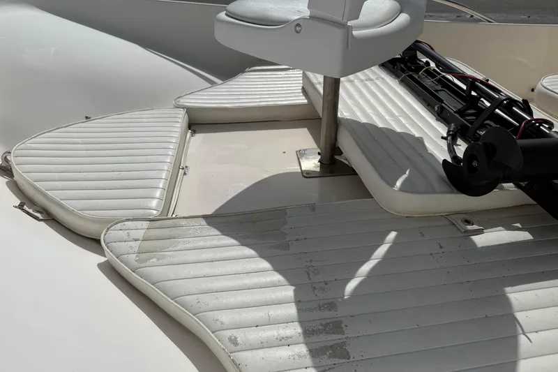 Slide: The Image of 2002 McKee Craft WayPoint boat interior with white cushioned seating and mounted equipment. - 9