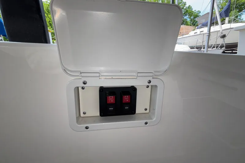 Slide: The Image of Electrical panel on 2025 Navan S30 boat with open cover, showing switches. - 35
