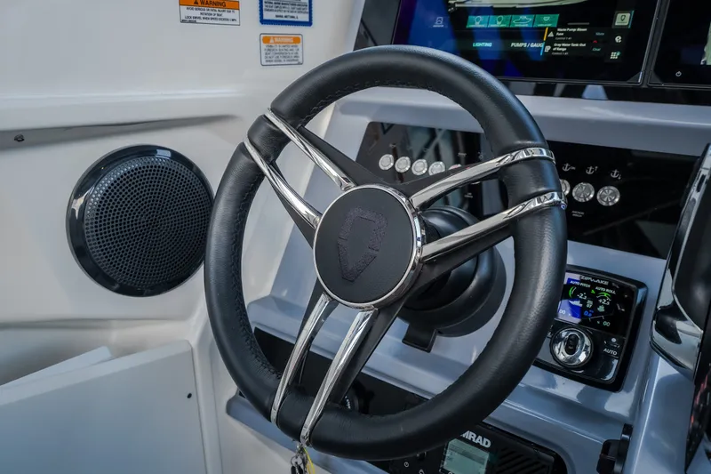 Slide: The Image of Steering wheel and dashboard of 2025 Navan S30 boat, featuring modern controls and displays. - 47