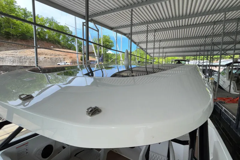 Slide: The Image of 2025 Navan S30 boat docked under a metal canopy with lush greenery in the background. - 57