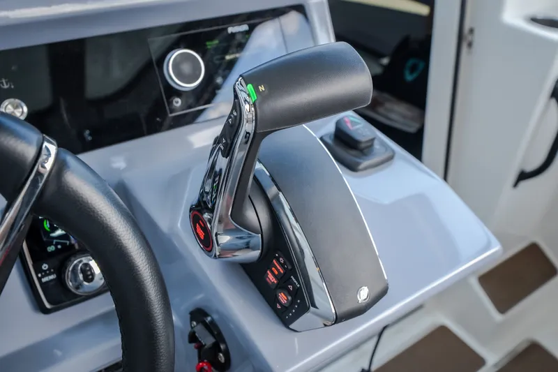 Slide: The Image of Control panel of 2025 Navan S30 boat, featuring modern throttle and steering wheel. - 32
