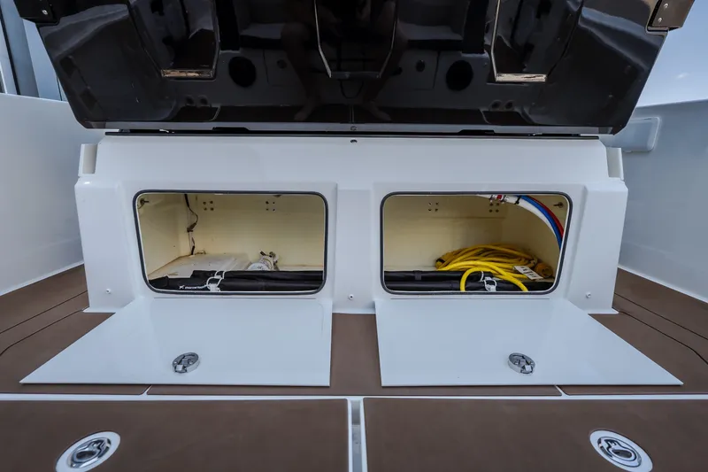 Slide: The Image of Storage compartments on a 2025 Navan S30 boat, featuring organized cables and equipment. - 21