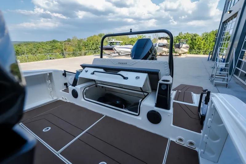 Slide: The Image of Navan S30 2025 boat interior with open storage compartment, docked outdoors under cloudy sky. - 42