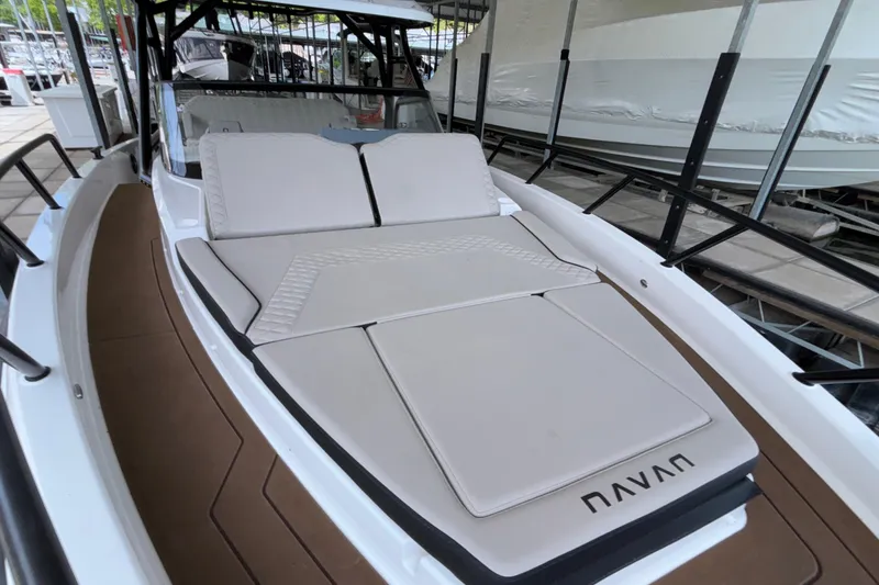 Slide: The Image of 2025 Navan S30 boat with sleek design and comfortable seating at a marina. - 53