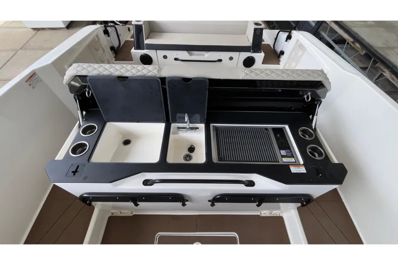 Slide: The Image of 2025 Navan S30 boat interior with sink, grill, and cup holders. - 32