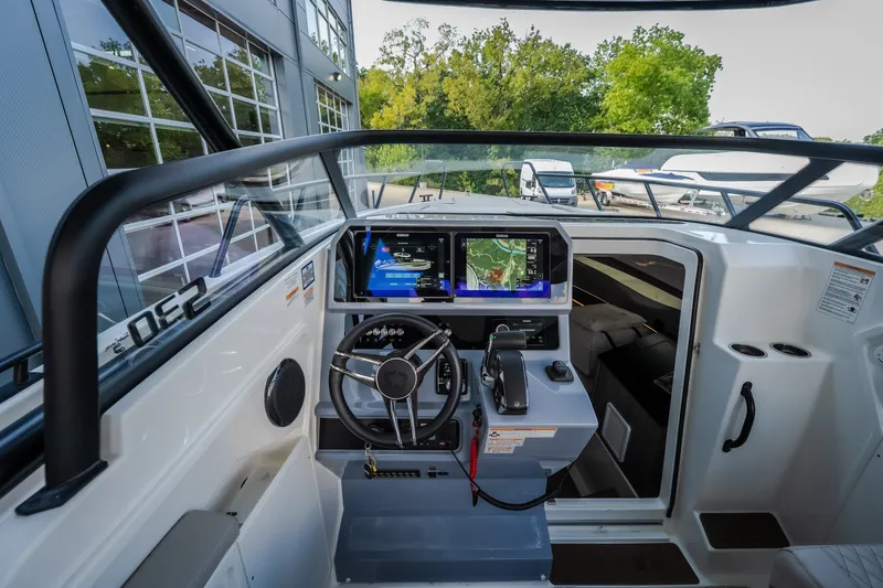 Slide: The Image of 2025 Navan S30 boat cockpit with modern navigation system and steering wheel. - 29