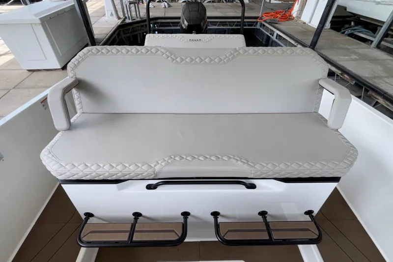 Slide: The Image of 2025 Navan S30 boat seat with quilted upholstery and armrests in a marina setting. - 33