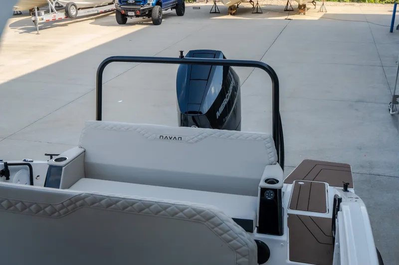 Slide: The Image of 2025 Navan S30 boat interior with outboard motor in a marina setting. - 40