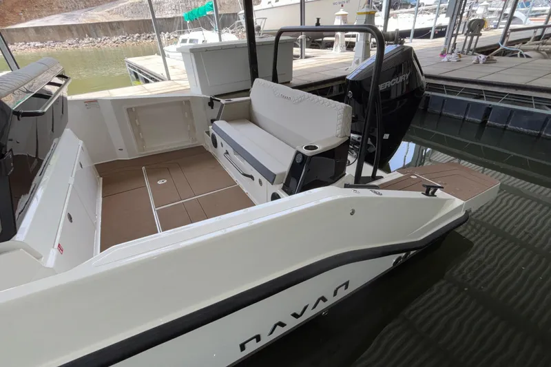 Slide: The Image of 2025 Navan S30 boat interior with seating and Mercury engine at a dock. - 13
