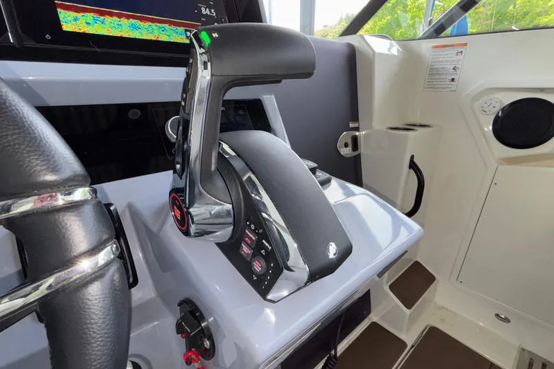 Slide: The Image of Control panel of 2025 Navan S30 boat with steering wheel and throttle lever. - 47