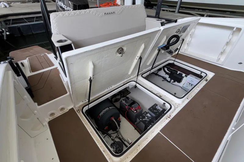 Slide: The Image of 2025 Navan S30 boat with open storage compartments and visible engine components. - 22