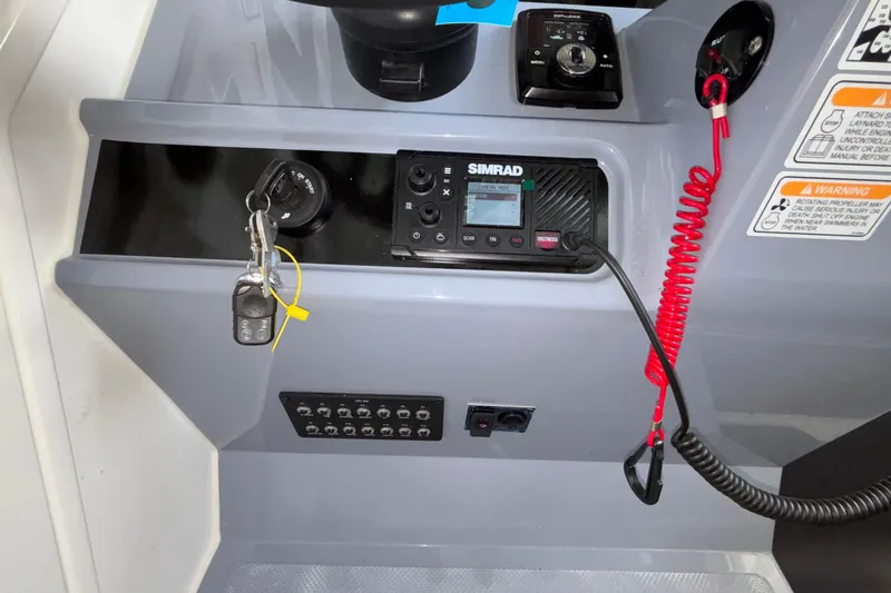Slide: The Image of Control panel of 2025 Navan S30 boat featuring Simrad electronics and safety instructions. - 62