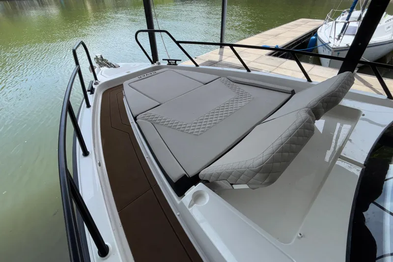 Slide: The Image of Luxurious 2025 Navan S30 boat with cushioned deck, docked by the water. - 58