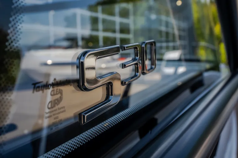Slide: The Image of Close-up of 2025 Navan S30 logo on vehicle window. - 26