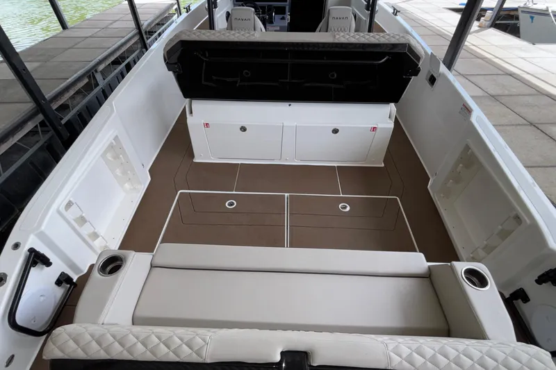Slide: The Image of 2025 Navan S30 boat interior with cushioned seating and storage compartments. - 15
