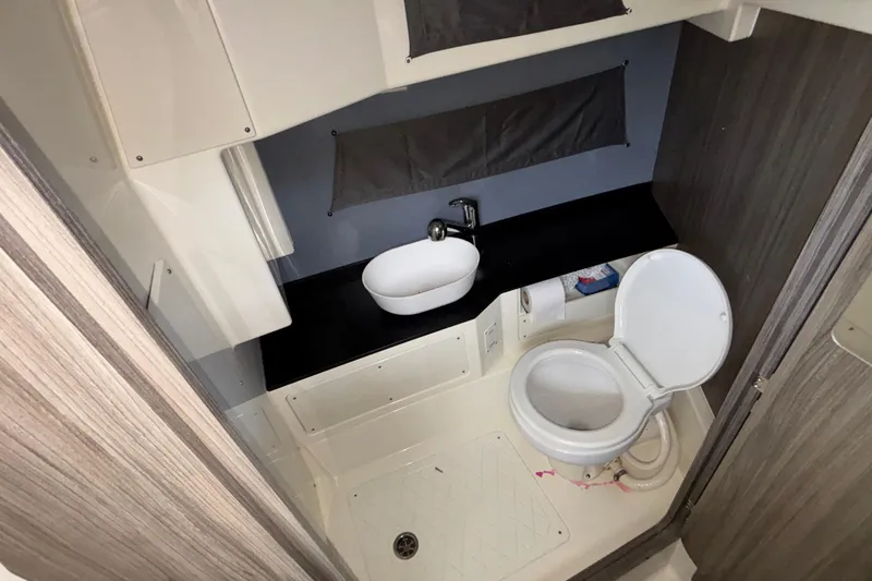 Slide: The Image of Compact bathroom in 2025 Navan S30 with toilet, sink, and shower area. - 70