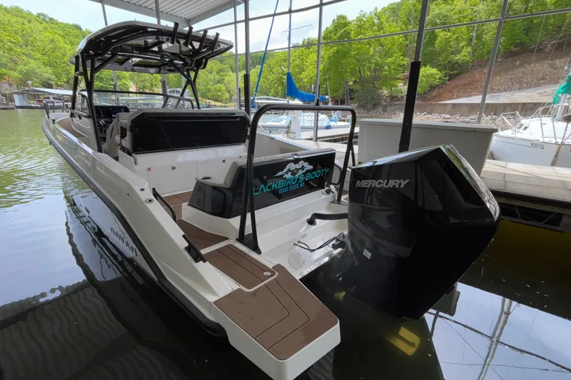 Slide: The Image of 2025 Navan S30 boat with Mercury engine docked in a marina. - 10