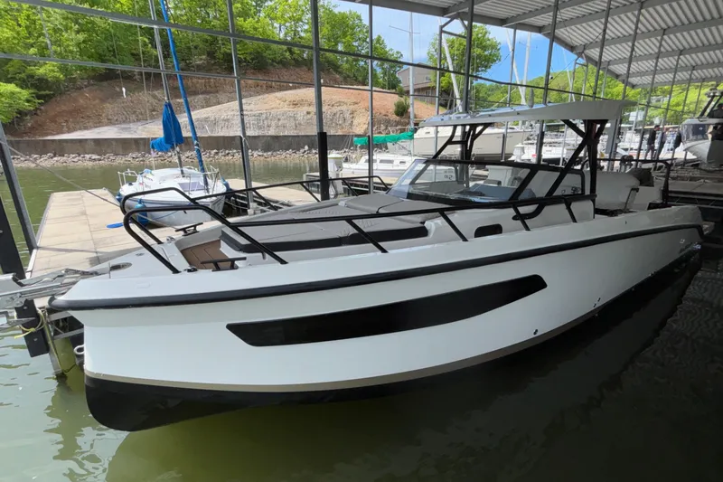 Slide: The Image of 2025 Navan S30 boat docked in a marina under a covered structure. - 11