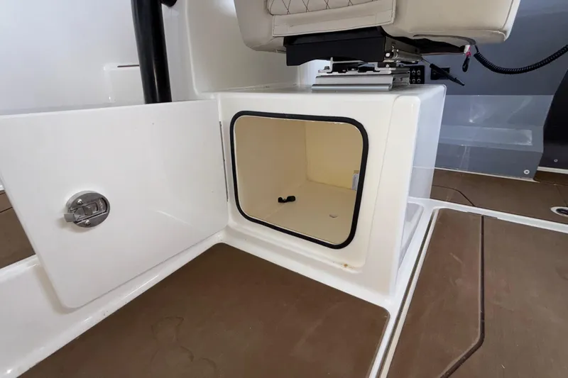 Slide: The Image of Open storage compartment on 2025 Navan S30 boat with brown flooring. - 39