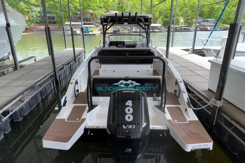 Slide: The Image of 2025 Navan S30 boat docked, featuring a powerful Mercury 400 V10 engine. - 9