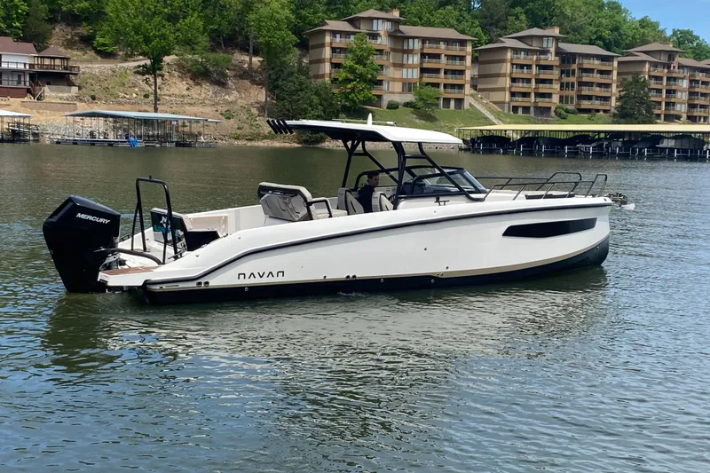 Slide: The Image of 2025 Navan S30 boat on a lake with modern buildings in the background. - 4
