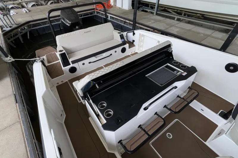 Slide: The Image of 2025 Navan S30 boat interior with seating and built-in grill, docked at marina. - 30