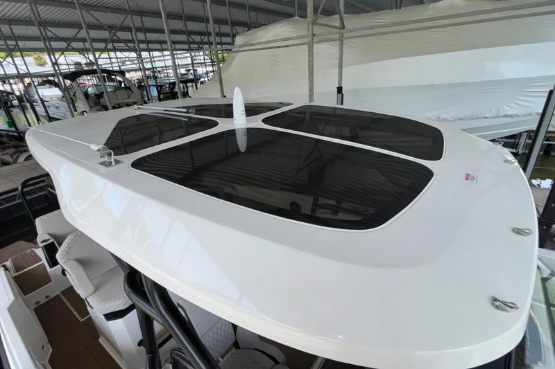 Slide: The Image of 2025 Navan S30 boat roof with sleek design and tinted windows in marina setting. - 60